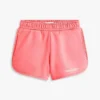 Pantaloncini da bambina con logo Tommy glitterato Pantaloncini da bambina con logo Tommy glitterato