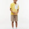 Polo elasticizzata con logo a blocchi di colore per bambini Polo elasticizzata con logo a blocchi di colore per bambini