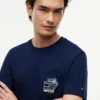 T-shirt con tasca e logo bandiera floreale T-shirt con tasca e logo bandiera floreale